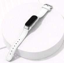 White leather watch band for Fitbit Inspire 3 displayed on a stand