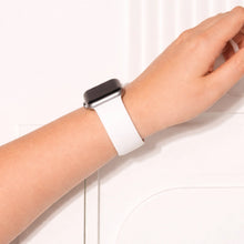 White silicone Apple Watch wristband worn on wrist with soft flexible fit