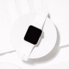 White silicone watch strap for Apple Watch displayed on minimal white background