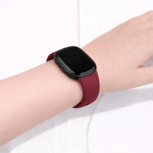 Wine red wristband worn on the wrist, compatible with Fitbit Versa 4