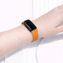 Orange watch band for Fitbit Inspire 3 worn on the wrist